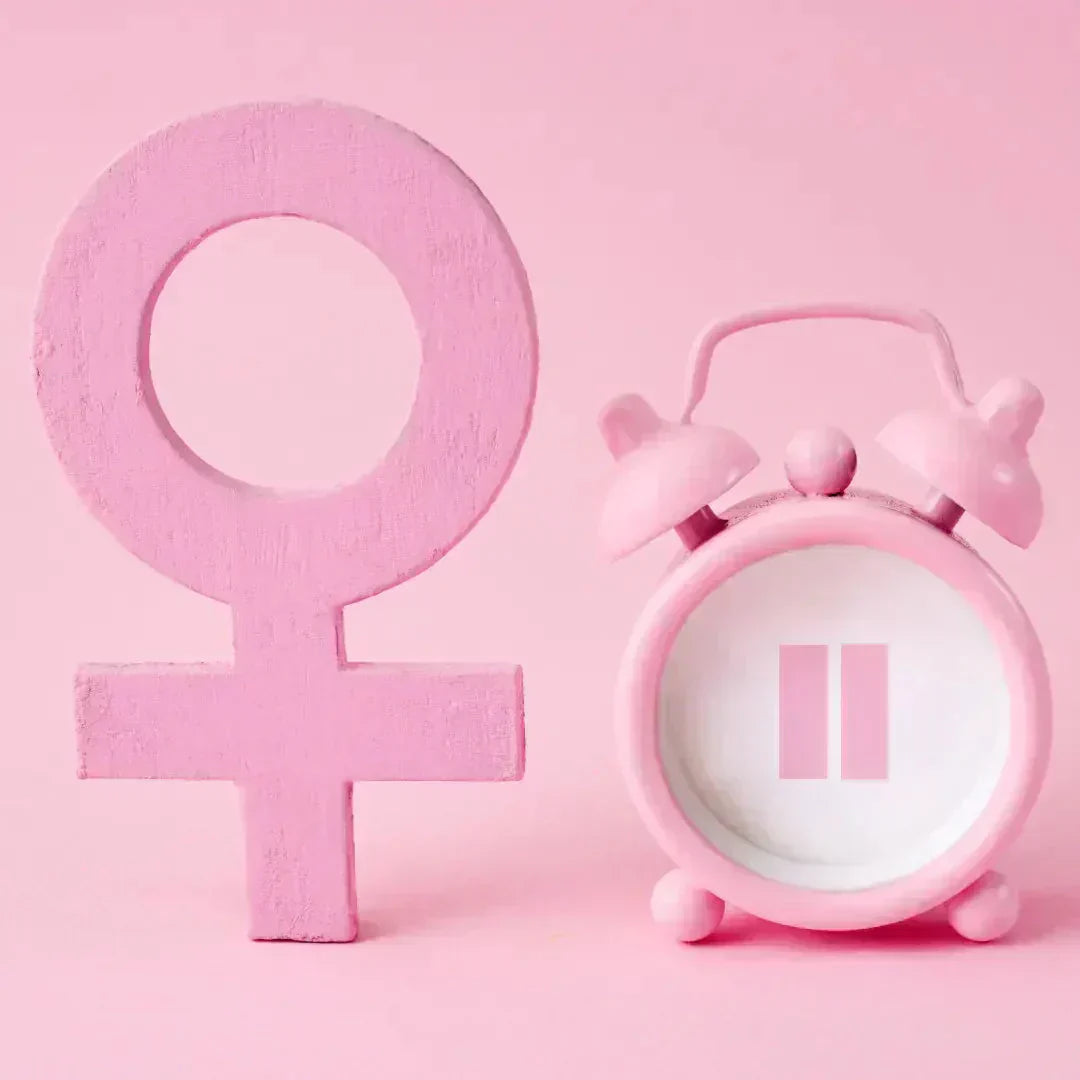 female symbol and clock with pause symbol